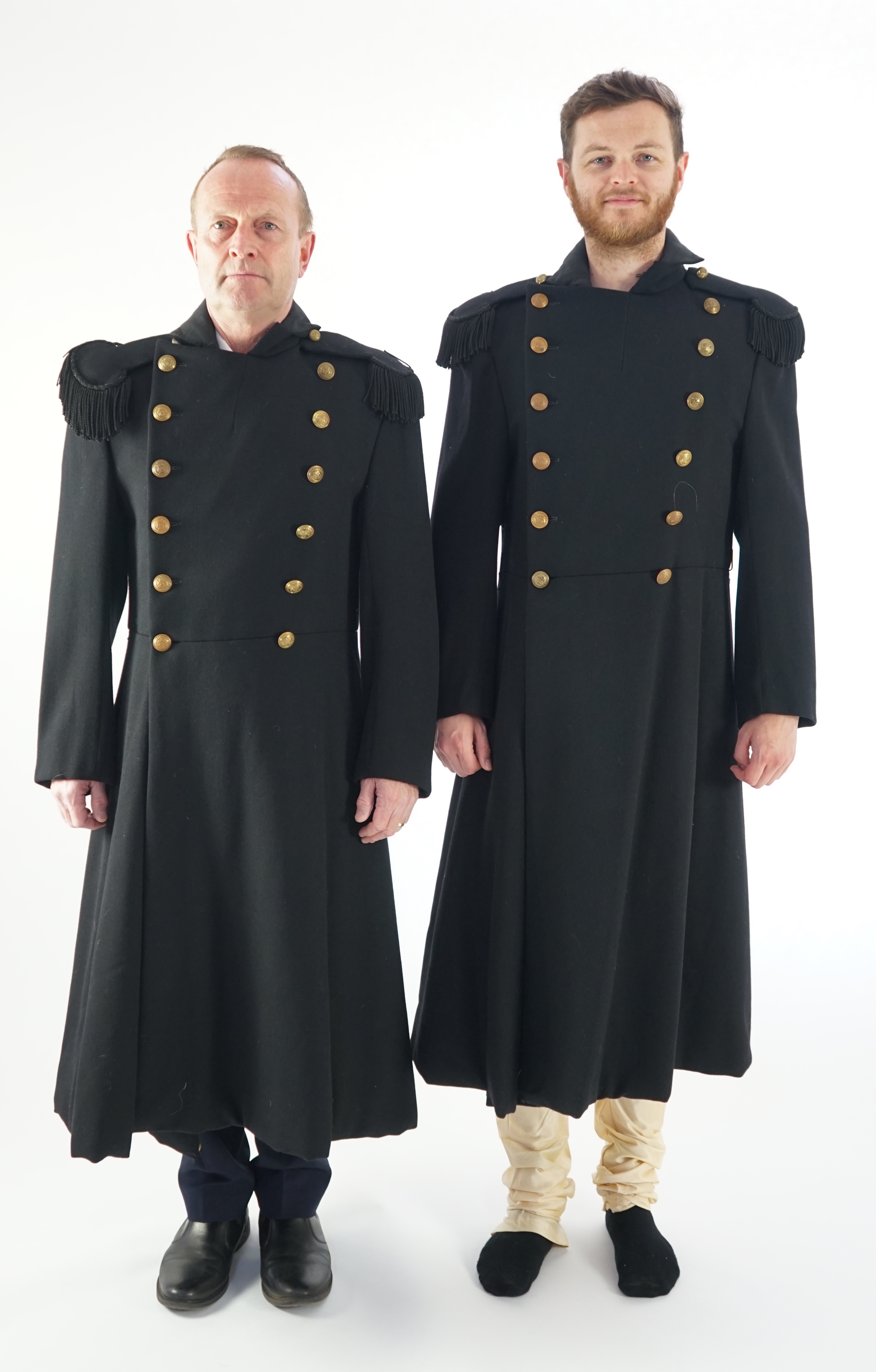 Two black military great coats with epaulettes and buttons. Ex Royal Opera House 'Tosca'